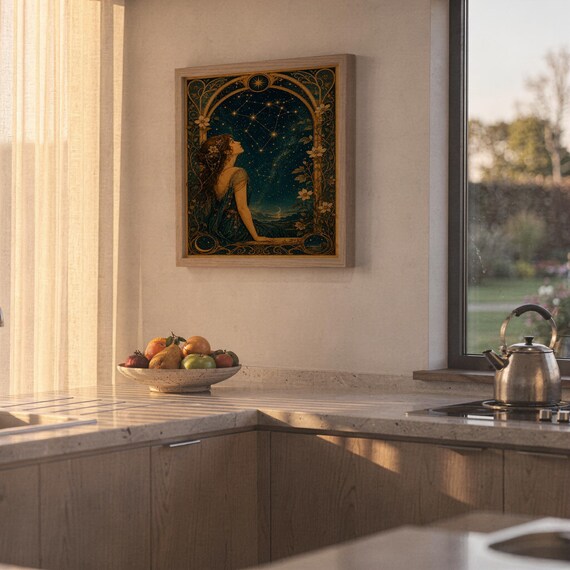 Celestial woman wall art print hanging above a stone countertop with a fruit bowl in a sunny kitchen.