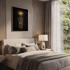 Celestial hand wall art print hanging above a bed with sage green pillows in a calm neutral bedroom.