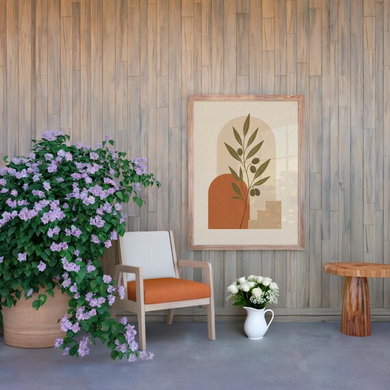 Earthy wall art poster in spacious living room with plants and armchair