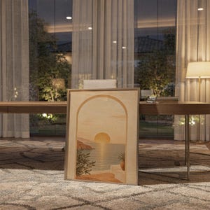 Mediterranean sunset arch print hanging above a stone countertop with a fruit bowl in a sunny kitchen.