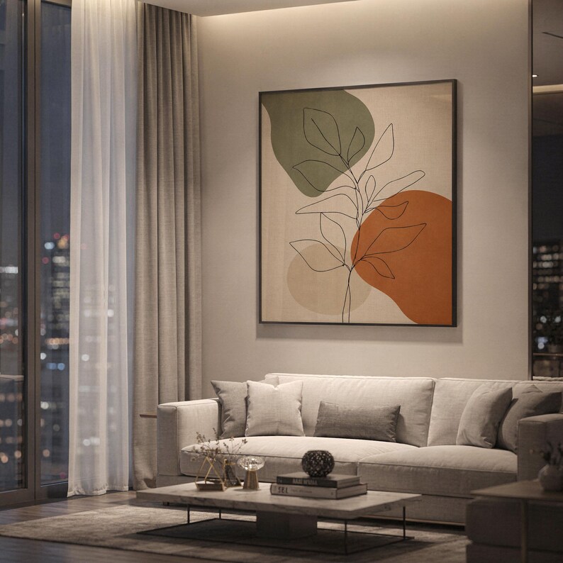 ramed abstract botanical wall art hanging in a cozy apartment living room with warm evening lighting.