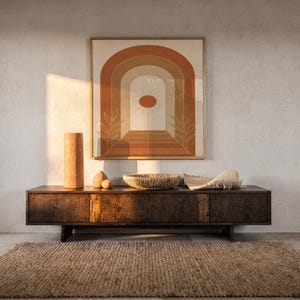 Boho arch sun wall art print hanging above a dark wood console and jute rug in a warm neutral interior.