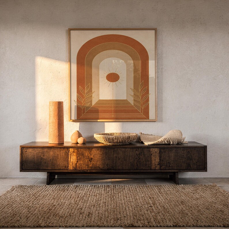 Boho arch sun wall art print hanging above a dark wood console and jute rug in a warm neutral interior.