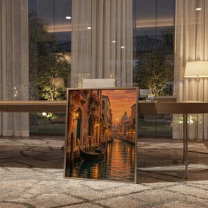 Venice canal sunset wall art print standing on a wooden desk in a home office in warm evening light.