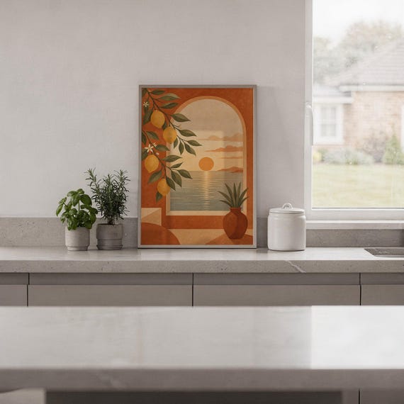 Mediterranean lemon and sea view arch print standing on a white kitchen counter beside potted herbs.
