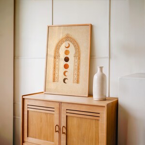 Scandinavian neutral wall art framed print on a wooden dresser next to a ceramic white vase⁠