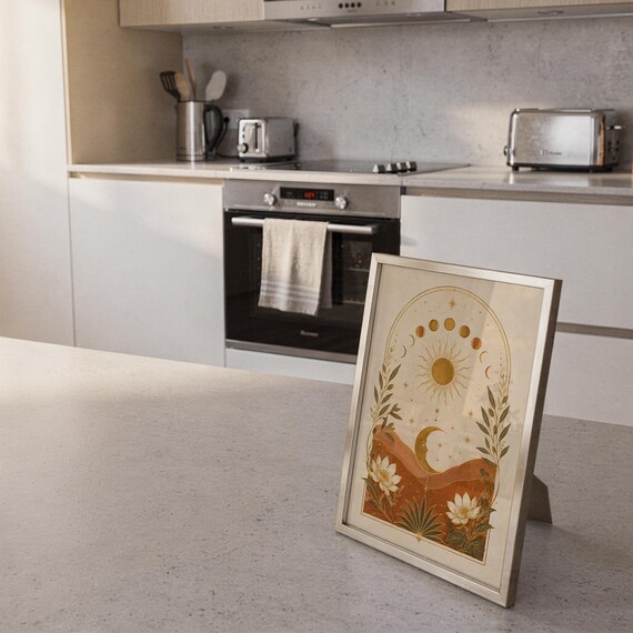 Celestial sun and moon wall art print framed and displayed in a modern home interior.