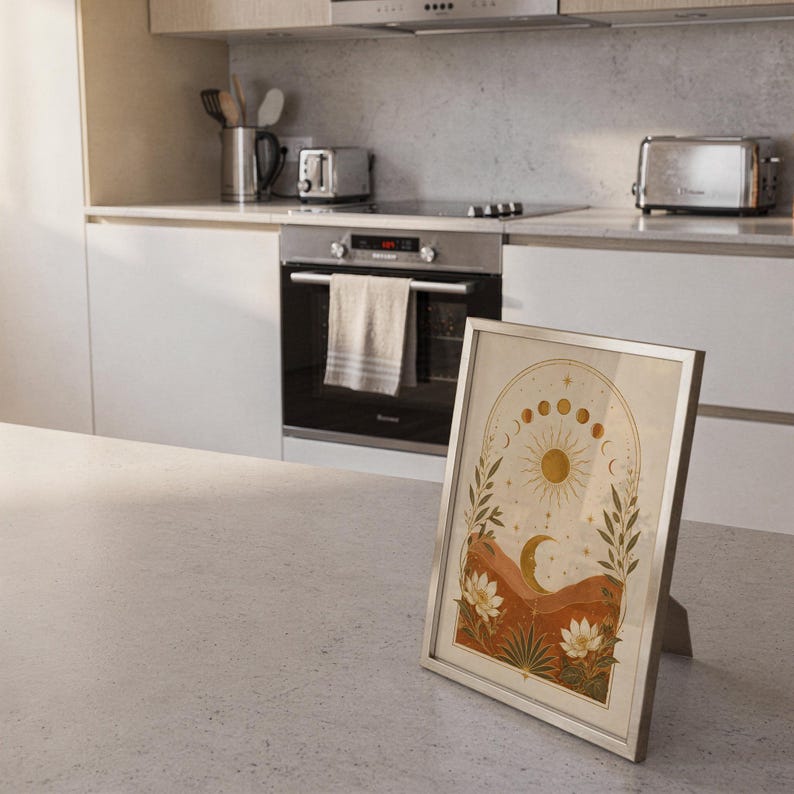 Celestial sun and moon wall art print framed and displayed in a modern home interior.