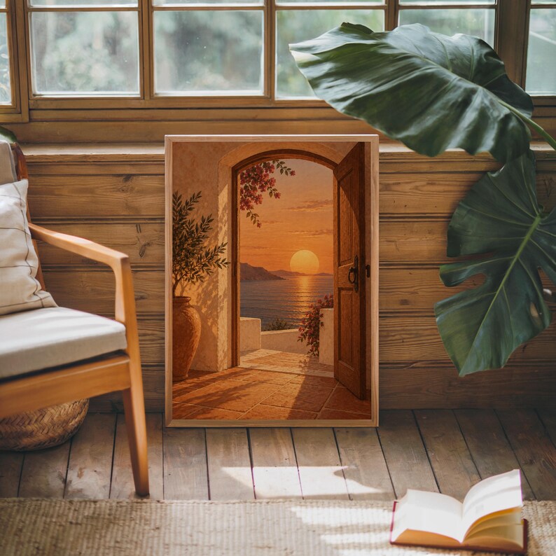 Mediterranean sunset doorway wall art print leaning against warm wood paneling beside a wooden armchair and a monstera plant.