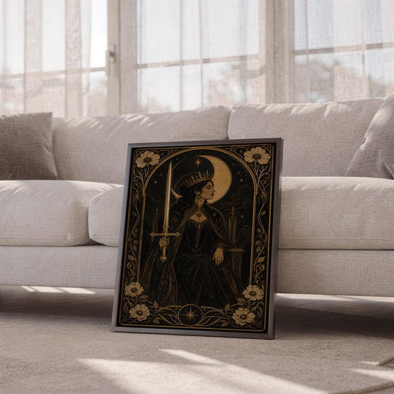 Gothic moon queen wall art print leaning against a white sofa in a bright living room with sheer curtains.
