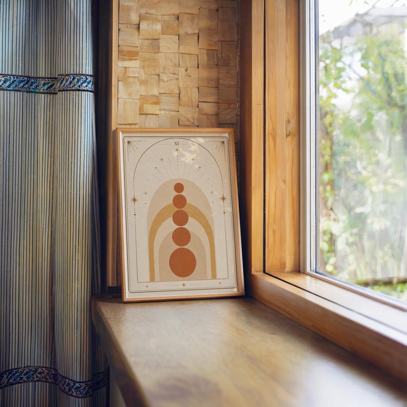 Minimalist terracotta circles print framed on wooden window sill with soft natural light.