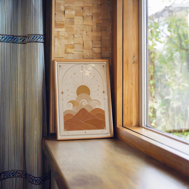 Neutral celestial ocean print framed on wooden window sill with soft natural light.