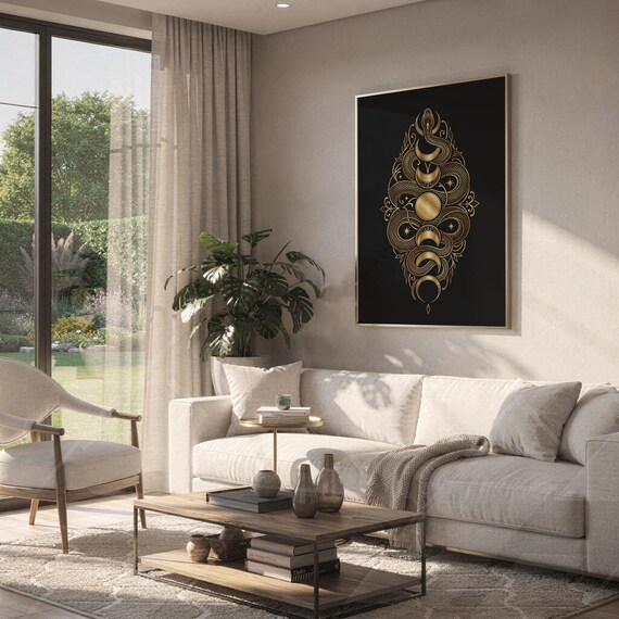 Gold snake moon phase wall art print hanging above a white sofa in a living room with garden views.
