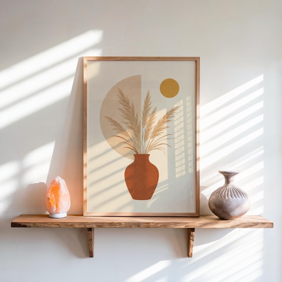 Pampas grass print in terracotta vase on shelf with window blind shadows