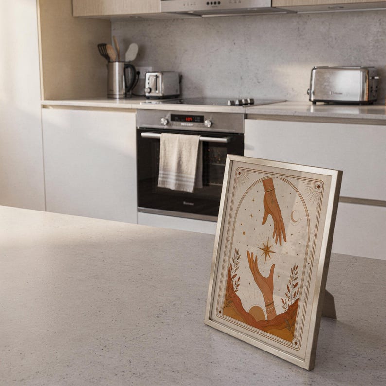 Vintage style hands tarot poster framed on kitchen island counter in modern bright home.