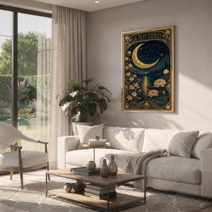 A framed vertical art print titled La Nuit Etoilee hanging on a living room wall above a white sofa.