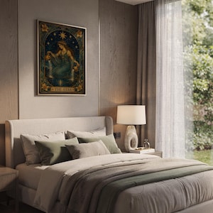 The star tarot card wall art print hanging above a bed with sage green pillows in a calm neutral bedroom.