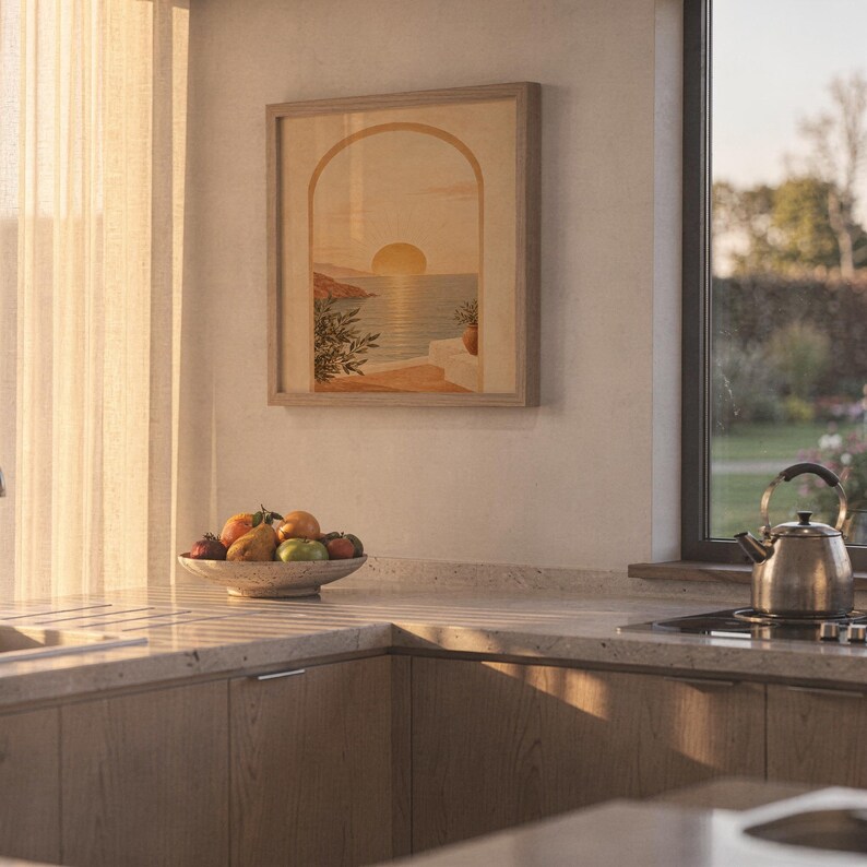 Mediterranean sunset arch print standing on a wooden desk in a home office in warm evening light.