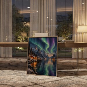 Aurora borealis mountain landscape wall art print standing on a wooden desk in a home office in warm evening light.