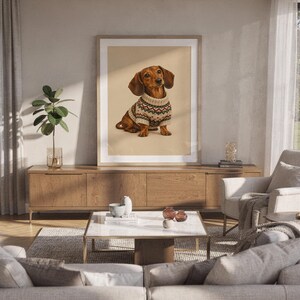 Dachshund sweater wall art print hanging above a white sofa in a living room with garden views.