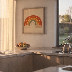 Boho earth tone rainbow print hanging above a stone countertop with a fruit bowl in a sunny kitchen.