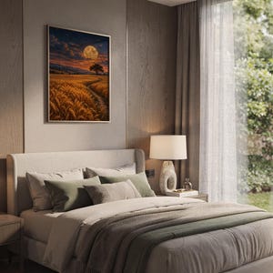 Moon wall art print hanging above a bed with sage green pillows in a calm neutral bedroom.