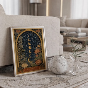 Moon phase wall art print standing on a countertop in a modern white kitchen.