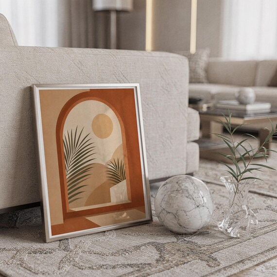 Botanical arch palm poster framed on carpet floor next to crystal ball decor in home.