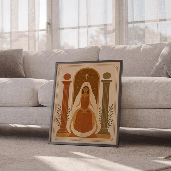 Mid-century modern terracotta arch poster in a thin frame sitting on the carpet in front of a cozy white sofa.