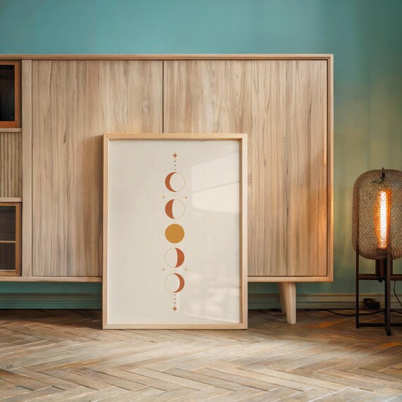 Celestial moon phases wall art print leaning against light wooden sideboard console