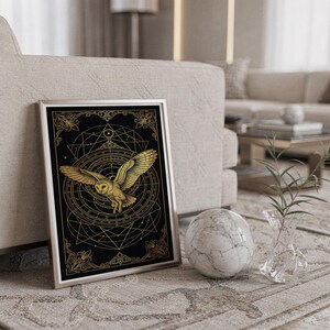 Celestial owl wall art print standing on a countertop in a modern white kitchen.