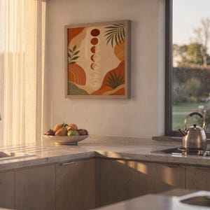 Boho moon phases art print hanging in a high-rise apartment living room with a city skyline view.