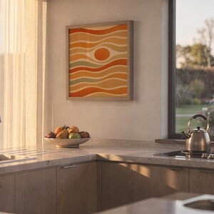 Abstract wavy sun print hanging in a high-rise apartment living room with a city skyline view.