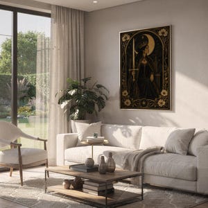 Gothic moon queen wall art print hanging above a white sofa in a living room with garden views.