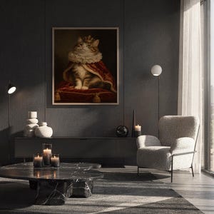 Royal cat portrait wall art print hanging above a white sofa in a living room with garden views.