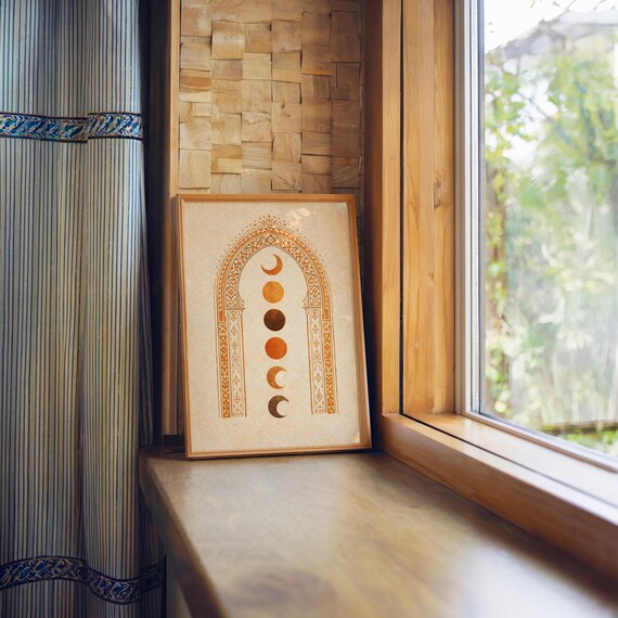 Warm aesthetic framed celestial art print resting on a wooden windowsill overlooking nature⁠