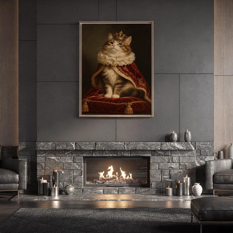 Royal cat portrait wall art print hanging above a stone countertop with a fruit bowl in a sunny kitchen.