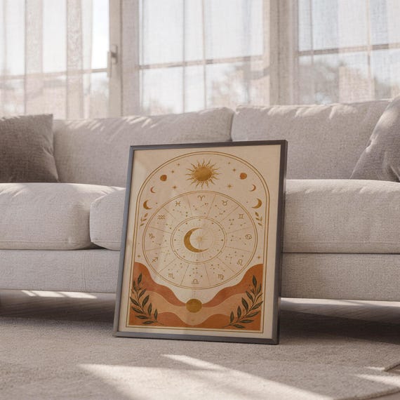 Zodiac wheel wall art print leaning against a white sofa in a bright living room with sheer curtains.