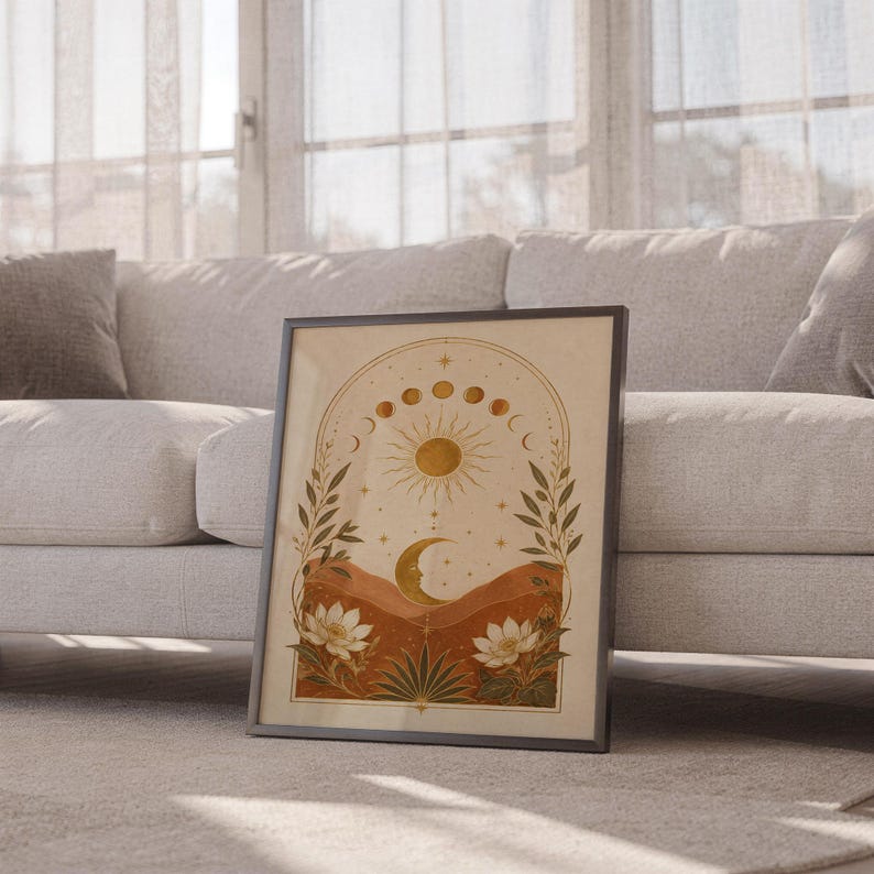 Celestial sun and moon wall art print leaning against a white sofa in a bright living room with sheer curtains.