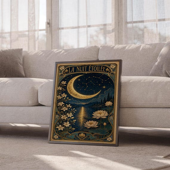 A framed Art Nouveau moon poster leans against a light fabric sofa.