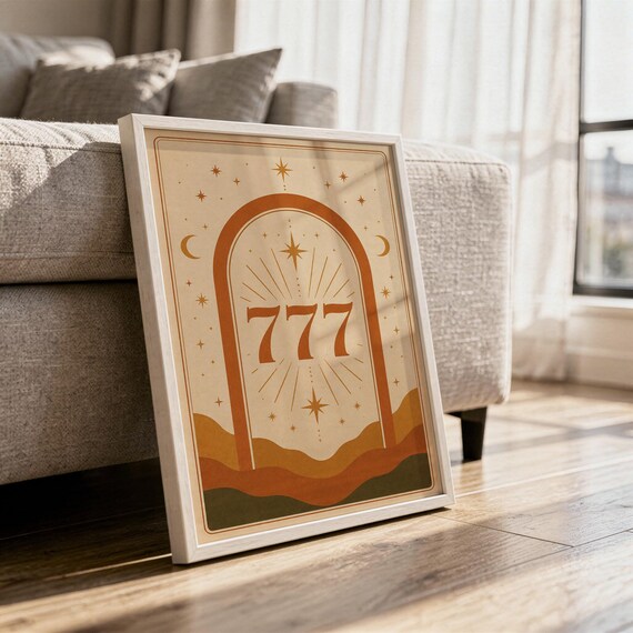 Spiritual 777 angel number print in a sleek frame resting on the floor against a sofa with natural sunlight shadows.