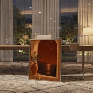 Mediterranean night sea wall art print standing on a wooden desk in a home office in warm evening light.