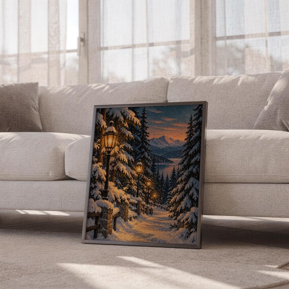 Snowy forest path wall art print leaning against a white sofa in a bright living room with sheer curtains.