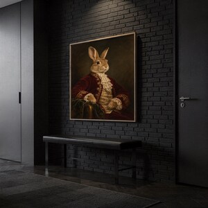 Regal rabbit portrait wall art print hanging above a dark wood console and jute rug in a warm neutral interior.