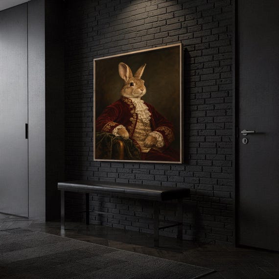 Regal rabbit portrait wall art print hanging above a dark wood console and jute rug in a warm neutral interior.