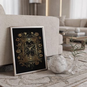 Gothic hourglass wall art print standing on a countertop in a modern white kitchen.