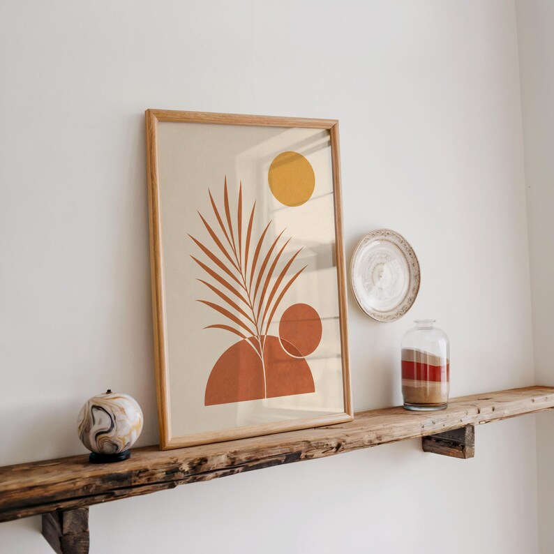 Warm earthy palm leaf art displayed on rustic wooden shelf in bright room