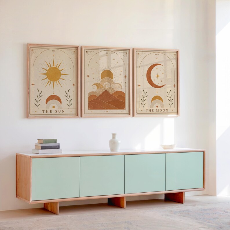 Set of 3 framed boho celestial art prints displayed above a wooden sideboard console.