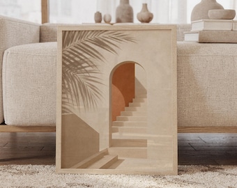 May include: A rectangular wall art print in a light wood frame featuring a beige and terracotta illustration of an arched doorway with stairs. A palm leaf shadow is cast across the left side of the scene, creating a layered effect with the architectural elements.