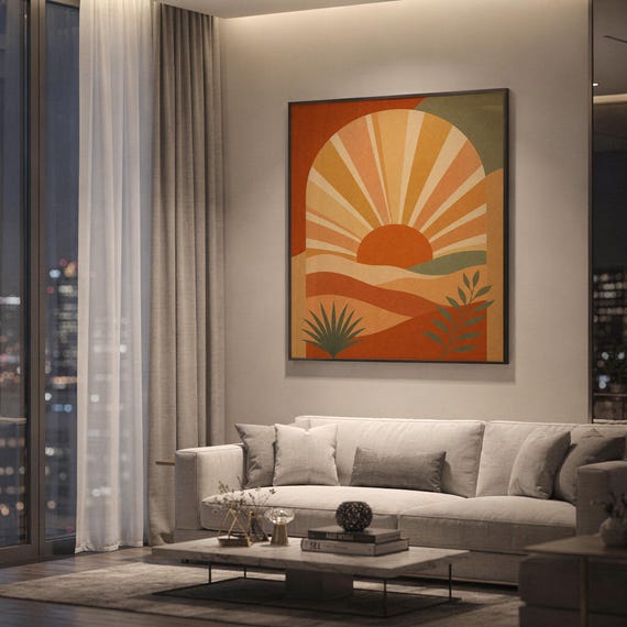 Boho sun arch print showing a rising sun inside an arch above layered hills with leaves in terracotta, ochre, peach and muted sage, hanging above a light gray sofa in a modern living room with evening city views through tall windows.